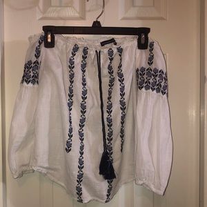 White off the shoulder top with blue embroidery